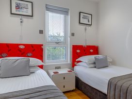 A bedroom with two beds and a window at Signature Lodge Pet 4 Portreath