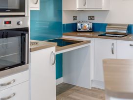A kitchen with a toaster and oven at Signature Assisted Living 5 Portreath