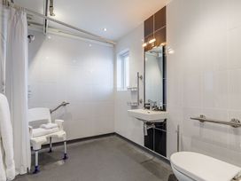 A bathroom with a shower and sink at Signature Assisted Living 5 in Portreath