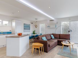 A living room with a sofa and dining table at Signature Assisted Living 5 Portreath