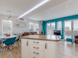 A living room with a table and chairs at Signature Assisted Living 5 in Portreath