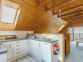A kitchen with sink and cupboards at Scandinavian Lodge 6 Portreath