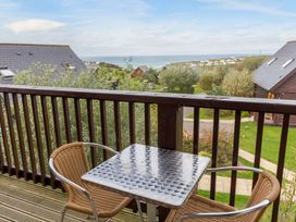 A balcony with a table and chairs at Scandinavian Lodge 6 in Portreath