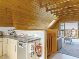 A kitchen with a sink and dishwasher at Scandinavian Hot Tub Lodge Pet Portreath