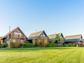 Four houses with a lawn area at Scandinavian Lodge Pet Portreath