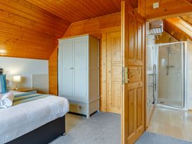 A bedroom with a bed and wardrobe at Scandinavian Assisted Living Portreath
