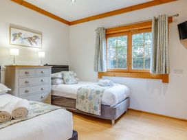 A bedroom with two beds and a dresser at Scandinavian Assisted Living – Pet Portreath