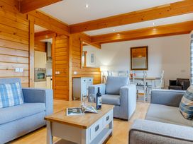 A living room with sofas and a coffee table at Scandinavian Assisted Living – Pet Portreath