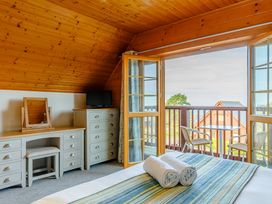 A bedroom with a bed and dresser at Scandinavian Assisted Living – Pet in Portreath