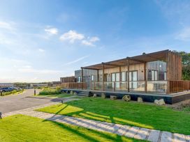 A house with a deck and garden area at Signature Lodge 6 Portreath