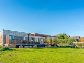 A house with a deck and windows at Signature Lodge Pet 6 Portreath