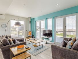 A living room with sofas and a coffee table at Signature Lodge Pet 6 in Portreath