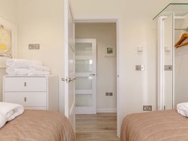 A bedroom with towels on a drawer unit at Signature Lodge Pet 6 in Portreath