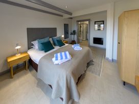 A bedroom with a bed and nightstand at Senara Hot Tub Lodge (Pet) Portreath