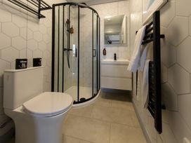 A bathroom with a shower and sink at Senara Hot Tub Lodge (Pet) Portreath