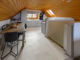 A kitchen with a table and chairs at Senara Hot Tub Lodge (Pet) Portreath