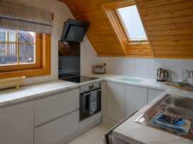 A kitchen with cabinets and appliances at Senara Hot Tub Lodge (Pet) Portreath