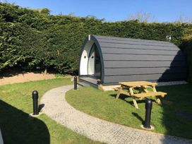 A pod with a pathway and seating area at Pod 3 (No Pets) Carnforth