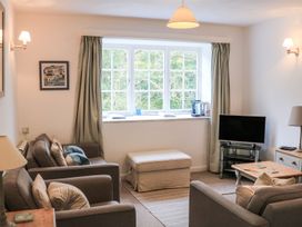 A living room with sofas and a television at 3 Moult Farm Cottages in Salcombe