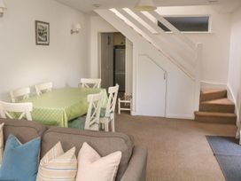 A living room with a dining table and chairs at 3 Moult Farm Cottages in Salcombe