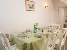 A dining room with a table set for meals at 3 Moult Farm Cottages in Salcombe