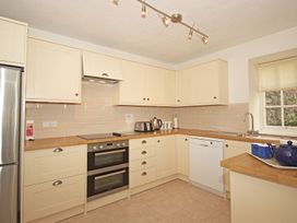 A kitchen with cabinets, stove, sink and appliances at 3 Moult Farm Cottages Salcombe