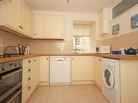 A kitchen with appliances and cabinets at 3 Moult Farm Cottages in Salcombe