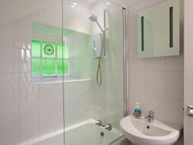 A bathroom with a shower and bathtub at 3 Moult Farm Cottages in Salcombe