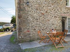 An outdoor area with a table and chairs at 3 Moult Farm Cottages Salcombe