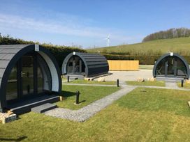Three camping pods with pathway and grass at Pod 4 (No Pets) Carnforth