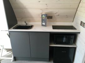 A kitchen with a sink, stove, microwave, and refrigerator at Pod 5 (Pet Friendly) in Carnforth