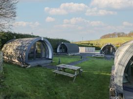 Pods in a garden area with a picnic table at Pod 6 (No Pets) in Tewitfield