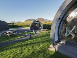 Outdoor area with glamping pods and picnic tables at Pod 6 (No Pets) Tewitfield