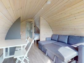 A living room with seating and dining area at Pod 8 (No Pets) in Carnforth
