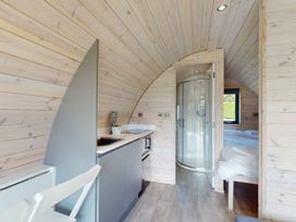 A kitchenette and shower within a pod at Pod 9 (No Pets) in Carnforth