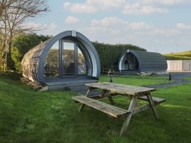 Two camping pods with a picnic table in front at Pod 9 (No Pets) Tewitfield near Carnforth