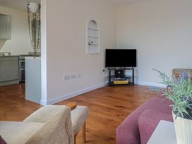 A living room with a television and chair at Fluta in Seaton