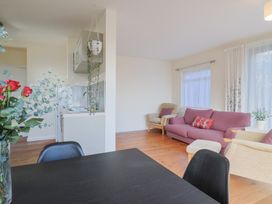A living room with a kitchenette and seating area at Fluta in Seaton