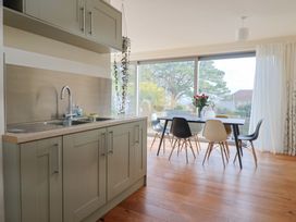 A kitchen with a sink and dining area at Fluta in Seaton