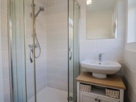 A bathroom with a shower and sink at Fluta in Seaton