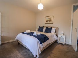 A bedroom with a bed and nightstand at Fluta in Seaton
