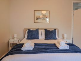 A bedroom with a bed and two nightstands at Fluta in Seaton