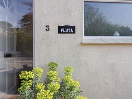 An entrance with a house number and sign for Fluta in Seaton