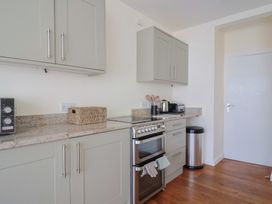 A kitchen with appliances and cabinets at Fluta in Seaton