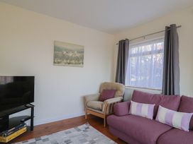 A living room with a sofa and armchair at Fluta in Seaton