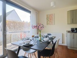 A dining room with a table set for dinner at Fluta in Seaton