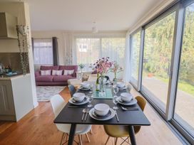 A dining area with a table set for meals at Fluta in Seaton