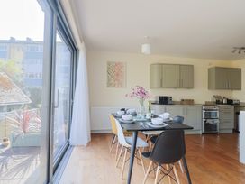 A kitchen with dining table and chairs at Fluta in Seaton