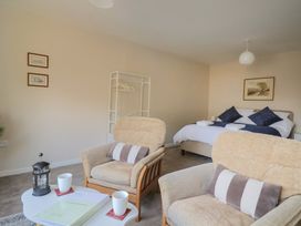 A bedroom with a bed and seating area at Fluta in Seaton