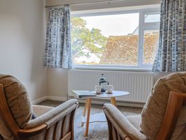 A living room with two chairs and a table at Fluta in Seaton
